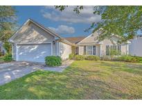 Charming single-story home showcasing a manicured lawn, two-car garage, and inviting front entrance at 4524 E Walkerton Rd., Myrtle Beach, SC 29579