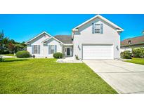 Charming two-story home with white siding, well-manicured lawn, and attached two-car garage at 501 Painted Duck Ct., Myrtle Beach, SC 29588