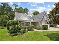 Charming two-story home featuring brick accents, a lush front yard, and manicured landscaping at 509 June Bug Ct., Myrtle Beach, SC 29588