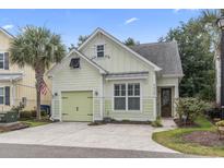 Charming light green single Gathering home with a well-manicured lawn and a one car garage at 6624 Lagoon Pl., Myrtle Beach, SC 29572