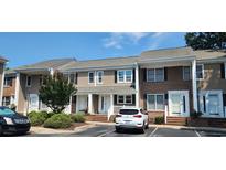 Charming townhome with a combination of tan siding and brick, a well-maintained lawn, and convenient parking at 6702 Jefferson Jefferson Pl. # F2, Myrtle Beach, SC 29572