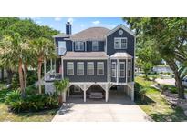 Charming two-story home with a covered front porch, a carport with swing and beautiful landscaping at 709 Triple Oak Ln., Garden City Beach, SC 29576