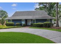 Charming one-story home featuring a circular driveway and well-manicured landscaping at 804 47Th Ave. N, Myrtle Beach, SC 29577