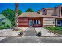 Charming single-story home with a manicured lawn and a pathway leading to the front door at 808 Myrtle Ct. # 808, North Myrtle Beach, SC 29582