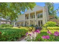 Charming home with lush landscaping, covered porch, and beautiful flowers along the walkway at 89 Cameron Ct., Pawleys Island, SC 29585