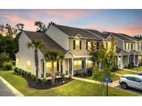 Charming townhomes displaying manicured lawns and stone accents, enhancing curb appeal at 1001 Dinger Ct. # 1001, Myrtle Beach, SC 29588