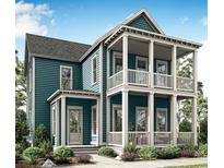 Charming two-story home showcasing double porches, beautiful blue siding, and a well-maintained, landscaped front yard at 1083 Milford Way, Myrtle Beach, SC 29588