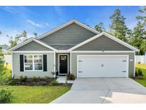 Charming single-Gathering home with an attached garage and manicured lawn at 113 Arbor Crest Ln., Tabor City, NC 28463
