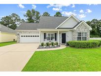 Charming single-story home featuring a well-manicured lawn, brick accents, and a two-car garage at 120 River Country Dr., Conway, SC 29526