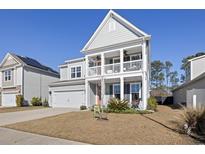 Charming two-story home boasts a double porch, well-maintained lawn, and inviting curb appeal at 1838 Zodiac Court, Myrtle Beach, SC 29577