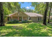 Charming single-story home with a well-manicured lawn and mature trees at 196 Weston Rd., Pawleys Island, SC 29585