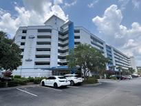 Harbourgate Resort condo building featuring ample parking and blue accents at 2100 Sea Mountain Hwy. # 520, North Myrtle Beach, SC 29582