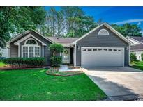 Charming single-story home with a two-car garage and beautiful landscaped front yard at 220 Gateway Dr., Little River, SC 29566