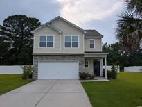Inviting two-story home with a well-manicured lawn, a two-car garage, and a stone-accented facade at 236 Haley Brooke Dr., Conway, SC 29526