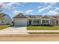 Charming single-story home featuring gray siding, blue shutters, and well-manicured lawn at 250 Six Mile Creek Dr., Georgetown, SC 29440