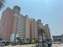 Large beachside condominium with palm trees, parking, and pedestrian crossing at 2801 S Ocean Blvd. # 1535, North Myrtle Beach, SC 29582