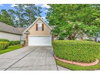 Charming home with a well-manicured lawn, mature trees, and a two-car garage at 2818 Sanctuary Blvd., Conway, SC 29526