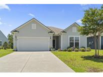 Charming one-story home with a well-maintained lawn, two-car garage, and a lovely landscaped front yard at 4136 Alvina Way, Myrtle Beach, SC 29579