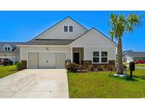 Charming single-Gathering home with well-manicured lawn, neutral siding, and a two-car garage in a sunny neighborhood at 4148 Da Vinci Dr., Myrtle Beach, SC 29579