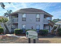 Attractive condo building with dual staircase entry and professionally maintained landscaping at 423 Tree Top Ct. # 23-B, Myrtle Beach, SC 29588