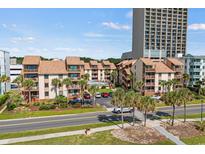 Beautiful condominium complex featuring well-maintained landscaping, a pool, and close proximity to the beach at 5515 N Ocean Blvd. N # 206, Myrtle Beach, SC 29577