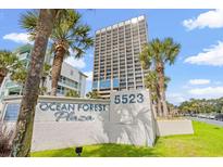 Exterior of the building with a view of the Ocean Forest Plaza sign, palm trees, and blue skies at 5523 N Ocean Blvd. # 2006, Myrtle Beach, SC 29577