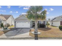 Charming single-story home with a well-manicured lawn and a white two-car garage at 755 Wintercreeper Dr., Longs, SC 29568