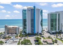 Oceanfront view of the Oceans One Resort with modern architecture and a bright blue design against a summer sky at 107 S Ocean Blvd. # 503, Myrtle Beach, SC 29577