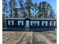 New construction home with dark siding, white trim, and professional installation of decorative stone skirting at 109 Forman Way, Aynor, SC 29511