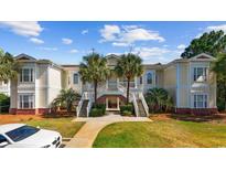 Charming condo complex with a beautifully landscaped entrance and inviting staircase at 139 Avian Dr. # 6-201, Pawleys Island, SC 29585