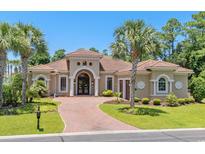 Stunning Mediterranean-style home with a red-brick driveway and lush tropical landscaping at 1694 Serena Dr., Myrtle Beach, SC 29579