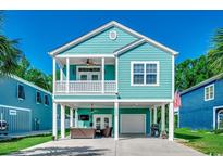 Charming raised beach home with a blue exterior, covered parking and second story balcony at 1733 24Th Ave. N, North Myrtle Beach, SC 29582