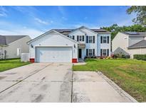 Charming two-story home featuring white siding, black shutters, solar panels, and a spacious driveway at 180 Weeping Willow Dr., Myrtle Beach, SC 29579