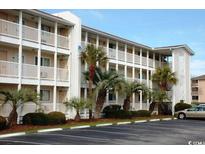 Charming condo complex with multiple floors, balconies, parking, and lush landscaping at 1919 Spring St. # B12, North Myrtle Beach, SC 29582