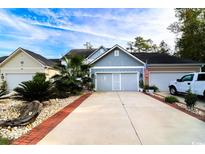 Charming home featuring a manicured yard, a spacious driveway and a well-maintained exterior at 2256 Heritage Loop # 2256, Myrtle Beach, SC 29577