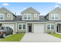 Charming townhome with a one car garage, black front door and muted green siding at 244 Jasper Overlook Way # 244, Myrtle Beach, SC 29588