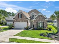 Charming brick home with a manicured lawn, two-car garage, and inviting curb appeal in a desirable community at 408 Capua Ct., Myrtle Beach, SC 29588
