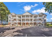 Attractive three-story condominium building featuring private balconies and dedicated parking spaces at 4400 Turtle Ln. # 2-D, Little River, SC 29566