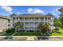 Three story condo complex featuring private balconies, stairwells, and manicured landscaping at 4683 Wild Iris Dr. # 103, Myrtle Beach, SC 29577
