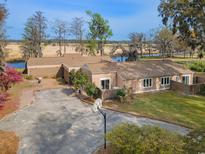 Stunning single-story house featuring an expansive driveway and a basketball hoop at 52 Trimmings Ct., Pawleys Island, SC 29585