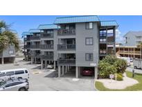 Beach condo complex offers covered parking and spacious balconies with ocean views, perfect for coastal living at 6001 N Ocean Blvd. # 137, North Myrtle Beach, SC 29582