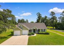Charming single-story home features a well-manicured lawn, two-car garage, and inviting front entrance at 943 Oak St., Aynor, SC 29511