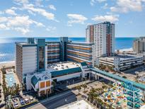 Stunning aerial view of the Landmark Resort featuring a beachfront location, pools, and modern architecture on a sunny day at 1501 S Ocean Blvd. # 945, Myrtle Beach, SC 29577