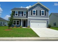 Charming two-story home with a manicured lawn, two-car garage, and inviting curb appeal at 204 Valerio St., Myrtle Beach, SC 29579