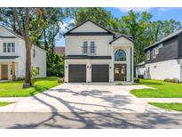 Beautiful two-story modern farmhouse-style home with a large driveway and a two-car garage at 2241 Sand Dunes Dr., Myrtle Beach, SC 29577