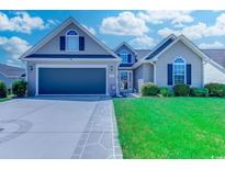 Charming home with a well-manicured lawn, a two-car garage, and lovely curb appeal at 35 Palmetto Green Dr., Longs, SC 29568