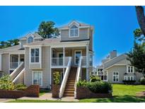 Charming townhouse with a welcoming entrance, staircase, and manicured landscaping at 3835 Masters Ct. # 135, Myrtle Beach, SC 29577