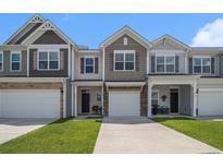 Charming townhomes featuring a mix of siding and brick accents, complemented by well-manicured lawns and a bright sky at 4051 Mclamb Ave. # 4051, Little River, SC 29566