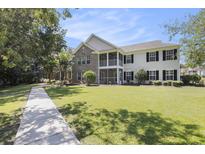 Inviting exterior view of a two-story condo with a well-manicured lawn and charming architectural details at 4645 Fringetree Dr. # 10B, Murrells Inlet, SC 29576