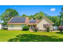 Charming home with a well-maintained lawn and solar panels for energy efficiency at 528 George Washington Trail, Georgetown, SC 29440